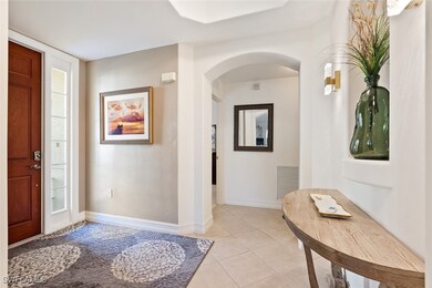 Entryway with light tile patterned floors, arched