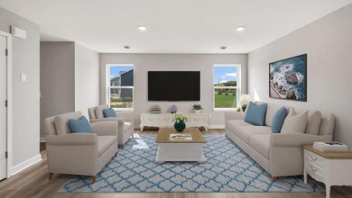 The spacious living room flows seamlessly to the dining and kitchen. Photo of actual home!