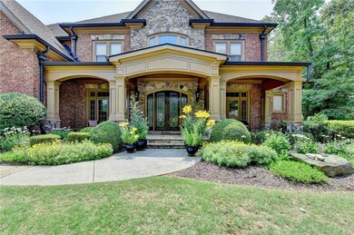 Property entrance featuring french doors, brick siding, and a porch