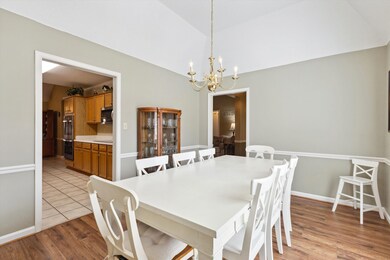 Dining room with an inviting chandelier, wood fini