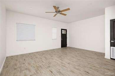 Spare room with visible vents, wood finished floors, baseboards, and ceiling fan
