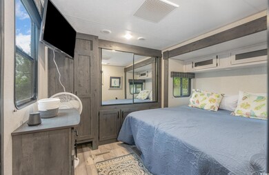 Bedroom with light wood-type flooring and a closet