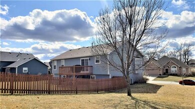 Great view of the fenced back yard and deck.
