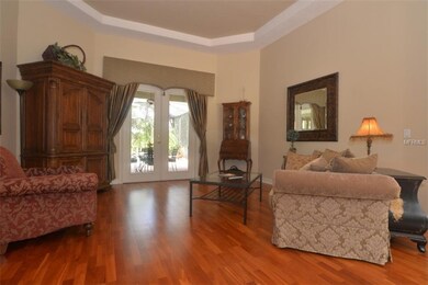 Formal living with views of pool, tray ceiling and