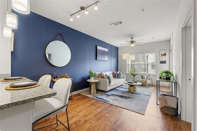 Living room featuring hardwood / wood-style floors and ceiling fan