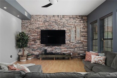 Living room with wood-type flooring and ceiling fan