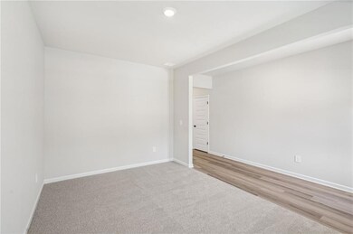 Carpeted spare room with baseboards and recessed lighting