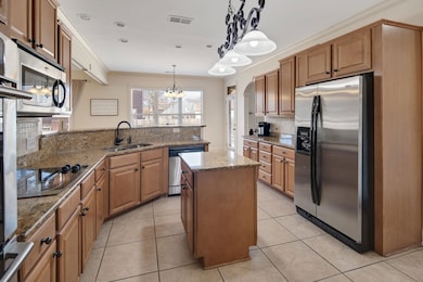 Kitchen with light tile patterned flooring, stainl