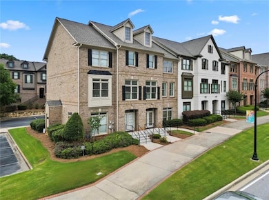 Multi unit property with brick siding, a residential view, and a front yard