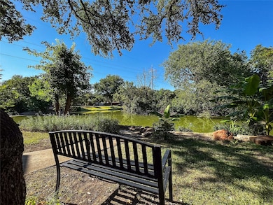 View of grassy yard with view of scattered trees and a water view