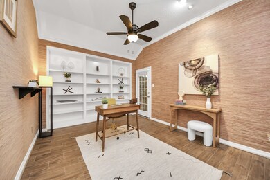 The office has high ceilings, crown molding, and b