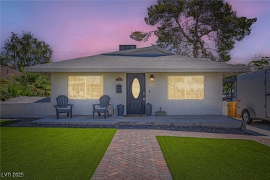 View of front of home featuring a yard and stucco