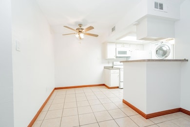 Kitchen featuring visible vents, light countertops