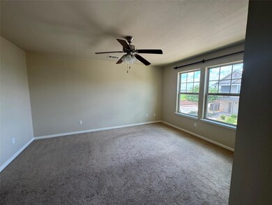 Carpeted spare room with a ceiling fan and a textured ceiling