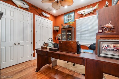 Office with a ceiling fan, light wood finished flo