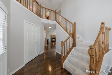 Beautiful foyer with grand staircase and large coa