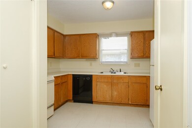 Kitchen featuring stove, dishwasher, light counter