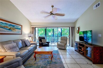 Tiled living room with ceiling fan, lofted ceiling