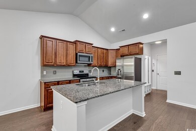 Kitchen featuring sink, dark wood-type flooring, l