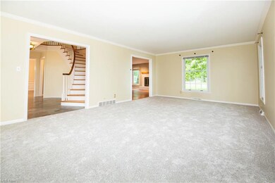 Empty room featuring ornamental molding and light 