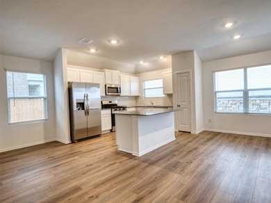 Kitchen with recessed lighting, light wood finish