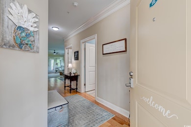 Foyer entrance with light wood finished floors, ba