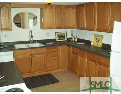 Kitchen. A lot of counterspace and tile flooring. 