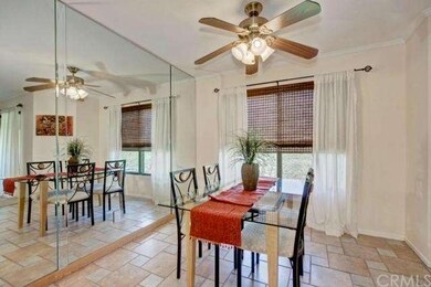 Dining area with ceiling fan and mirrored wall fea