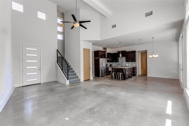Unfurnished living room with concrete flooring, s
