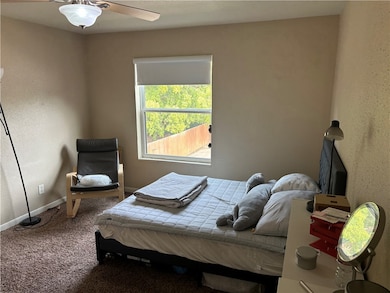Bedroom featuring ceiling fan and carpet floors