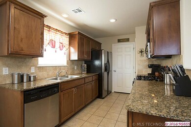 Gorgeous granite Kitchen features rich cabinetry w