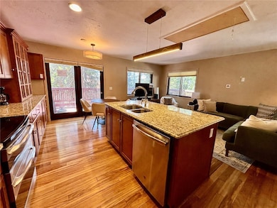 Kitchen with a sink, a center island with sink, li