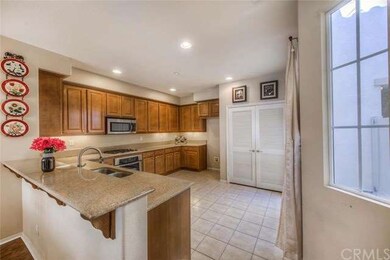 Nicely upgraded kitchen with granite counter tops, stainless steel appliance, tile flooring, recess lighting and laundry area