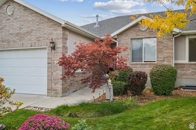 View of front of property with stucco siding, an attached garage, and roof with shingles