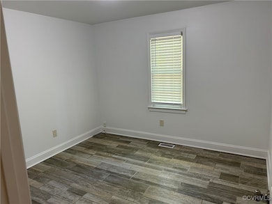 Spare room featuring baseboards