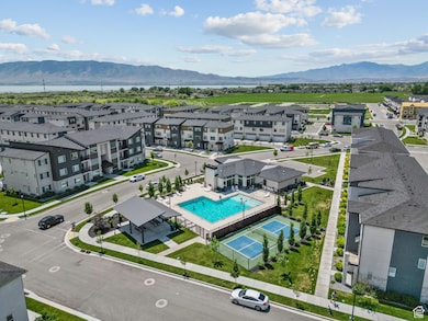 Aerial perspective of suburban area with a mountainous background and a pool
