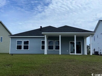 Back of property with a yard