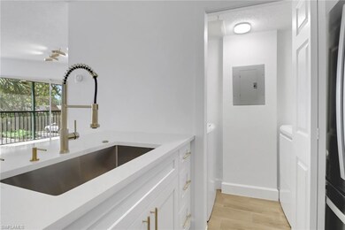 Kitchen with baseboards, electric panel, light cou