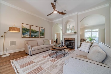 Living area with arched walkways, ornamental moldi