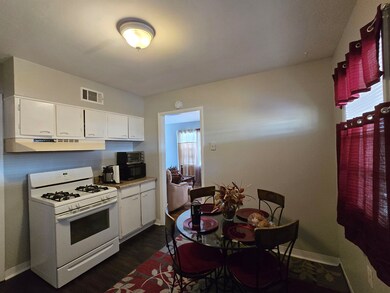 Kitchen featuring visible vents, black microwave, 