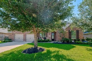The lush green lawn and mature trees create a picture-perfect exterior for this lovely home.