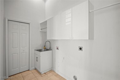 Washroom with light tile patterned floors, hookup