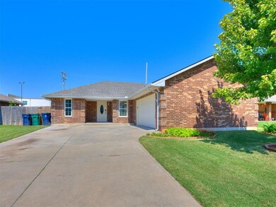 Ranch-style home with brick siding, an attached garage, concrete driveway, and roof with shingles