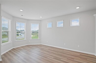 Spare room featuring light wood finished floors, healthy amount of natural light, and recessed lighting