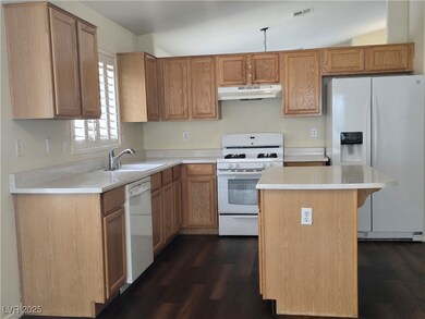 Kitchen featuring light countertops, white applian