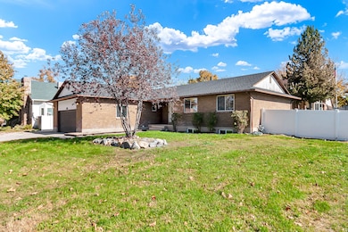 Ranch-style house featuring a garage, brick siding, and driveway