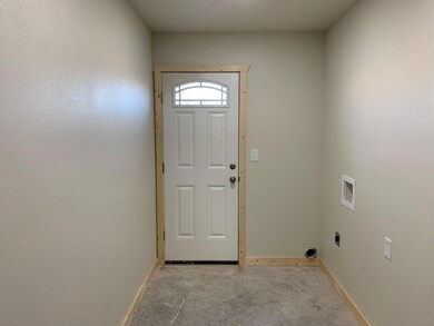 Doorway to outside featuring concrete floors and b