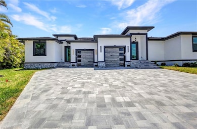 Prairie-style home featuring stucco siding, decora