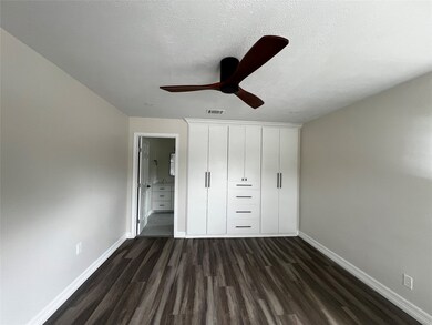 Primary bedroom with custom bult closets.