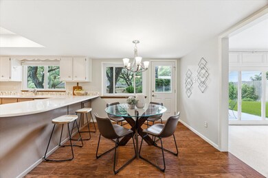 Dining room with a chandelier and dark wood-type 